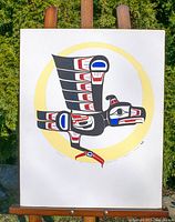 Front view of the Thunderbird original acrylic painting on stretched canvas mounted on an easel against a garden background.