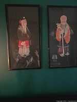 Photo of two framed vintage Japanese silk wall hangings with detailed traditional figure embroidery and black frames
