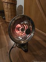 Photo of the vintage electric heater showing the reflective heating element and original cord.