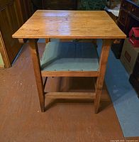 Photo of hardwood table showing rectangular tabletop, wooden legs, and internal structure beneath the top.