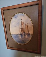 Framed watercolor artwork of sailing ships on water, signed by artist E.R.M.H., shown hanging on wall.