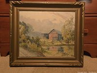 Framed oil painting featuring a red barn, pond, trees, and a path in a rural setting, signed by Pickering.