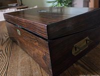 Exterior closed view highlighting rosewood grain and brass keyhole