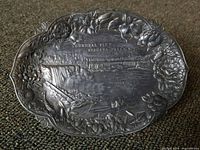 Photo showing the copper plated souvenir tray with detailed embossing of Niagara Falls and floral patterned border.