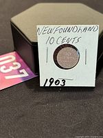 Photo of the 1903 Newfoundland 10 Cent silver coin in protective holder with label showing date and denomination.