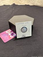 Photo of the 1916 Canada 10 Cent silver coin in a protective holder with label