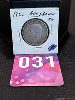 Florin coin in holder with label and lot number card
