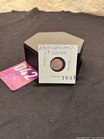 Photo of the 1941 Newfoundland 5 cents silver coin in a cardboard holder with handwritten label.