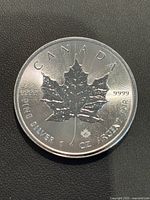 Obverse side of the 2015 Canadian Silver Maple Leaf showing the detailed maple leaf with purity and weight markings.