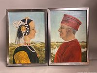 Two framed oil paintings by Mary Chorniuk showing profile portraits of a woman and a man in historical dress.