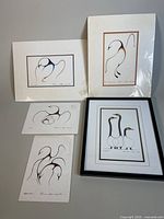 Four signed Clemence Wescoupe Indigenous prints, sizes 9x6, 6x9, 8.25x5.25, 5.25x8.25 inches with minimalist bird designs in black and white with color accents, displayed with white matting.