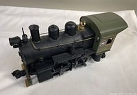 Front angle of black and olive-green scale model locomotive showing 'CNR 216' marking on cab and front light, highlighting overall condition and detailing.