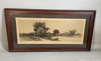 Framed etching showing full view of wooden frame, matting, and etched rural landscape