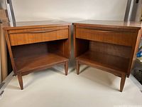 Pair of tables shown front view on white background