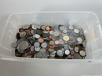 Large plastic bin containing a variety of mixed world coins