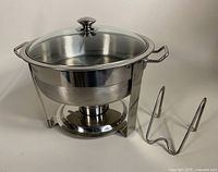 Full angled view of the Seville Classics chafing dish with glass lid, metal handles, and warming fuel tray separated to the side. Stainless steel with a reflective finish.