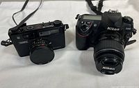 Front view showing both Nikon D200 and Yashica Electro 35 cameras on white background