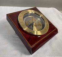 Vintage Seiko desk world time zone clock showing gold and black dial with world map and red airplane second hand in square wooden casing
