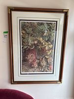 Framed print showing entire artwork with three rabbits under foliage in natural environment.