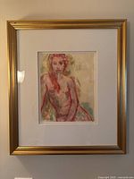 Framed signed figure study painting featuring a nude female figure with red hair, shown head-on, in a gold-tone frame with white matting.