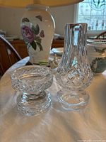 Photo of Heritage crystal candle holder base next to chimney showing diamond cut pattern and clear crystal material.