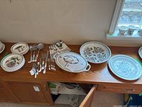 Overhead view of entire lot on countertop including plates, napkins, flatware and serving pieces