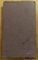 Brown fabric folio-style protective cover for Amazon Fire tablet with some wear and minor stains.