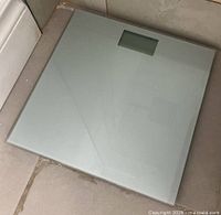 Glass top digital bathroom scale showing full surface and digital display window.