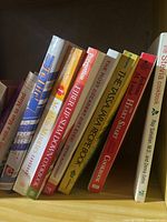 Cookbooks arranged on a shelf showing titles and authors of nine different books including Mediterranean diet and fiber-focused health books.
