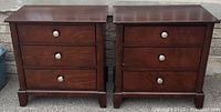 Front view of two matching dark brown nightstands side by side on concrete