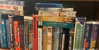Photo showing stack of DVDs including Return to Me, The Last Time I Saw Paris, and multiple Disney DVDs such as Tarzan and The Prince and the Pauper.