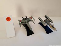 Photo showing two Star Wars starfighters on stands, the X-wing and Y-wing models, with a note indicating #35.