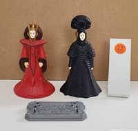 Two Star Wars figures and a display stand on a plain background with lot marker 22