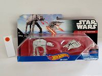 Front view of Hot Wheels Star Wars AT-AT and Rebel Snowspeeder models in original packaging.