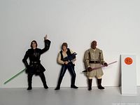 Photo showing three Star Wars figurines: Anakin Skywalker, Han Solo, and Mace Windu with their respective weapons.