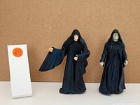Two Star Wars action figures of Emperor Palpatine and Count Dooku side by side with a lot number card 20.