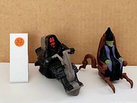 Image shows two Star Wars figures: Darth Maul on a speeder and Shmi Skywalker seated in a wooden chair on a tan background.