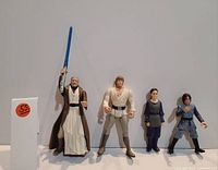 Photo showing 4 Star Wars action figures including Obi-Wan Kenobi, Luke Skywalker, Padmé Amidala and Anakin Skywalker in a row