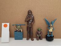 Five Star Wars collectible figurines arranged side by side against a plain brown background.