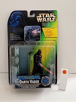 Front view of Darth Vader Star Wars figurine in original blister packaging with branding and graphics.