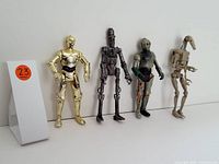 Four Star Wars figures side by side against white background