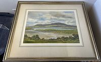 Framed watercolor landscape painting showing Ballynakill Bay from Noyard, Connemara, Ireland, under glass with visible reflections.