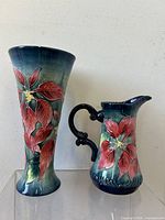 Pair of vintage Old Tupton Ware vase and jug with floral relief design and dark green gradient background.