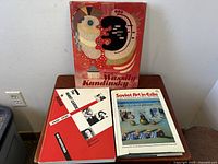 Set of three books on a wooden table including Wassily Kandinsky, Soviet Art in Exile, and The Avant-Garde in Russia 1910-1930