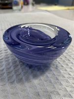 Top side view showing the purple swirl design with smooth rounded form and central depression.