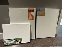 Photo showing two smaller 14x18 canvases and two of the larger canvases wrapped in packaging