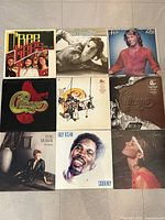 Overview photo of all nine vinyl records showing album cover art