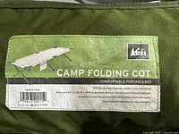 Close-up of the label on the carry case showing dimensions and REI branding.
