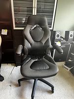 Front view of the ESS Essentials racing style gaming chair showing its ergonomic design, leather and mesh upholstery, and padded armrests.