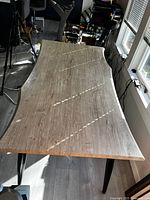 Top angled view of white oak live edge desk showing rectangular top with natural curved edges and wood grain surface.